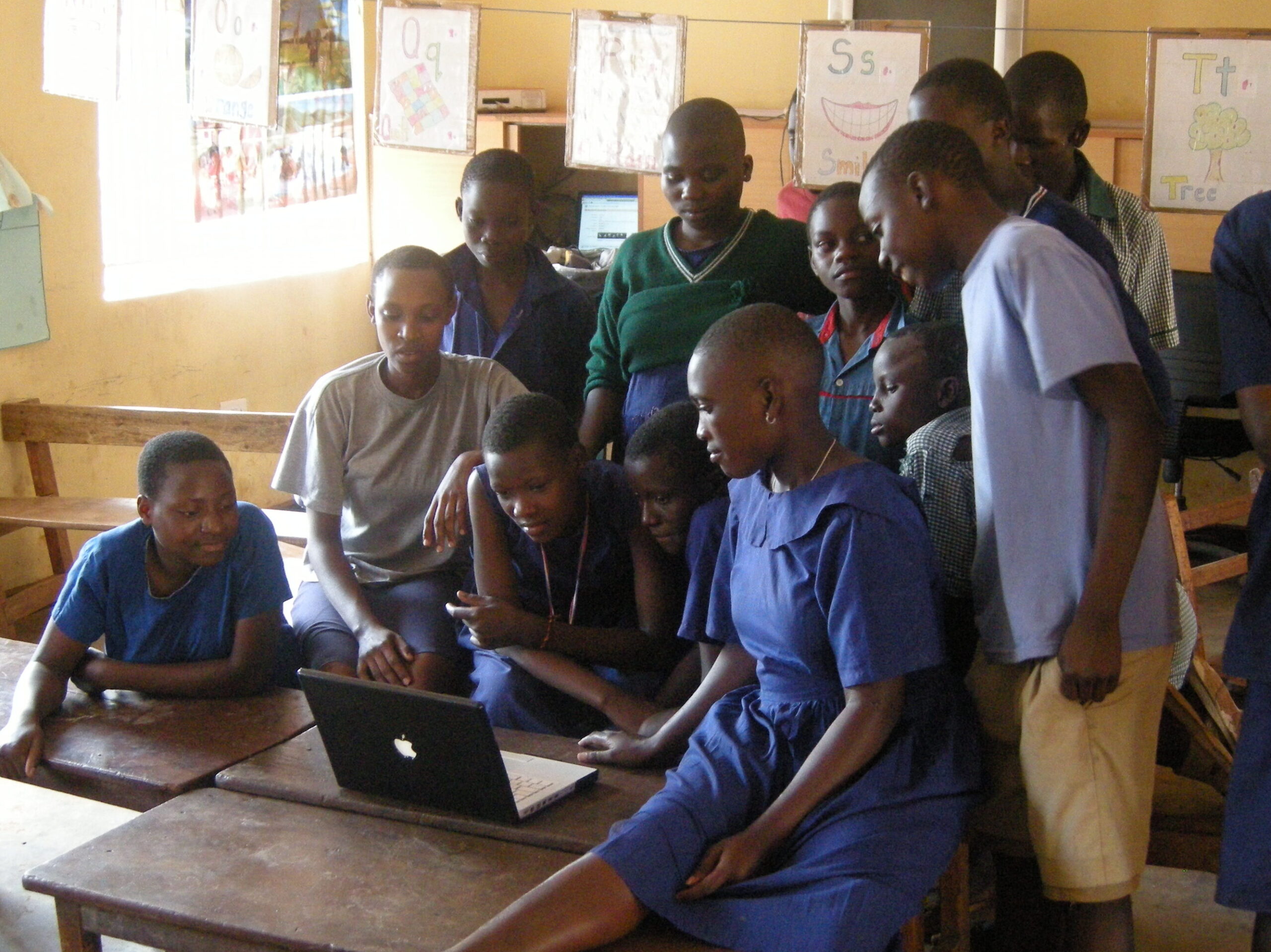 a group of children watch the final edit of their video in a classroom.